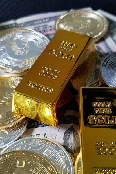 a pile of gold bars sitting on top of a pile of money