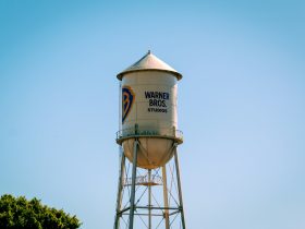 The warner bros. water tower against a blue sky.
