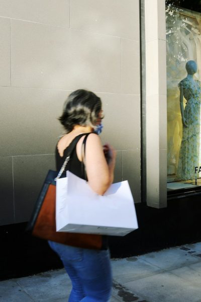 woman in white shirt and blue denim jeans standing in front of mirror