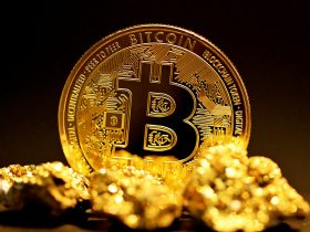 a bitcoin sitting on top of a pile of gold nuggets