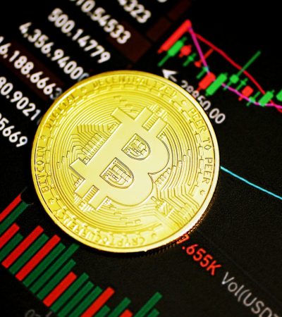 gold round coin on black surface