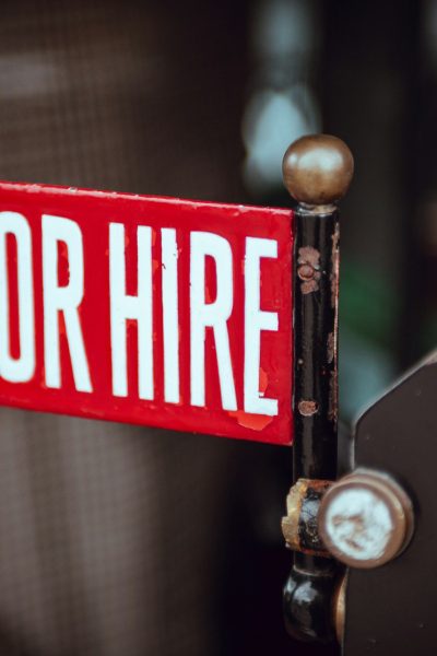 shallow focus photography of red and white for hire signage