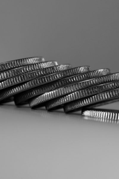 a stack of silver coins sitting on top of a table