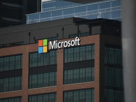 A tall building with a microsoft logo on top of it