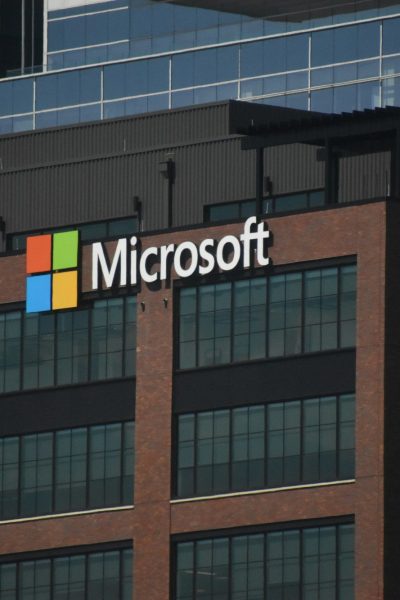 A tall building with a microsoft logo on top of it