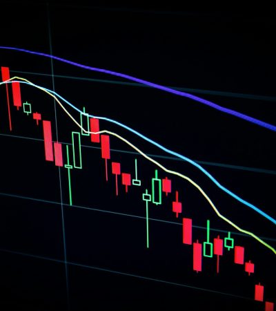 stock market candlestick chart on dark screen